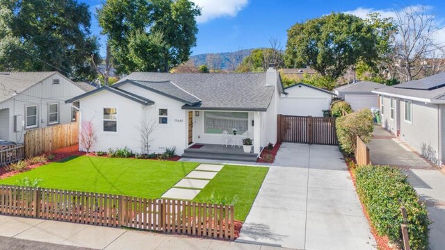 view of front facade with a mountain view and a front lawn