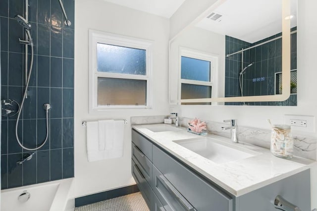 bathroom featuring vanity and tiled shower / bath combo