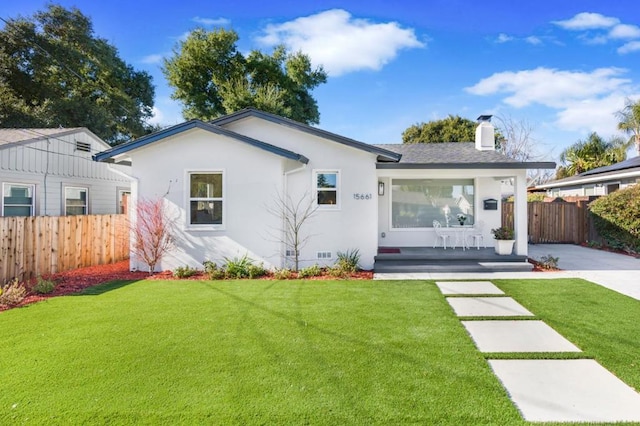 back of house with a lawn