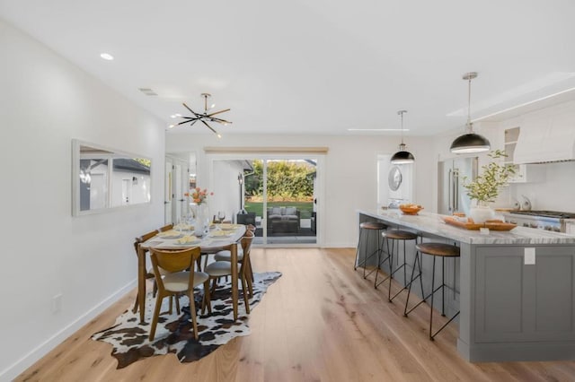 dining room featuring an inviting chandelier and light hardwood / wood-style floors