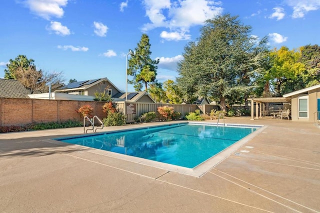 view of swimming pool with a patio