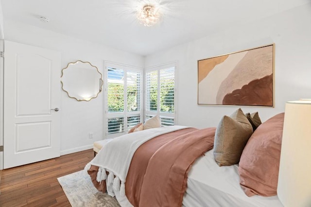 bedroom with dark hardwood / wood-style floors