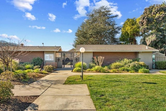 ranch-style home featuring a front yard