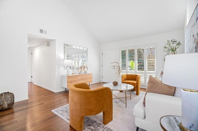 living room featuring plenty of natural light, hardwood / wood-style floors, and high vaulted ceiling