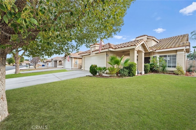 mediterranean / spanish home with a garage and a front lawn