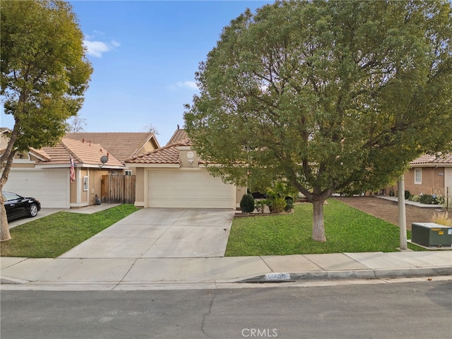 view of front of property with a garage and a front yard