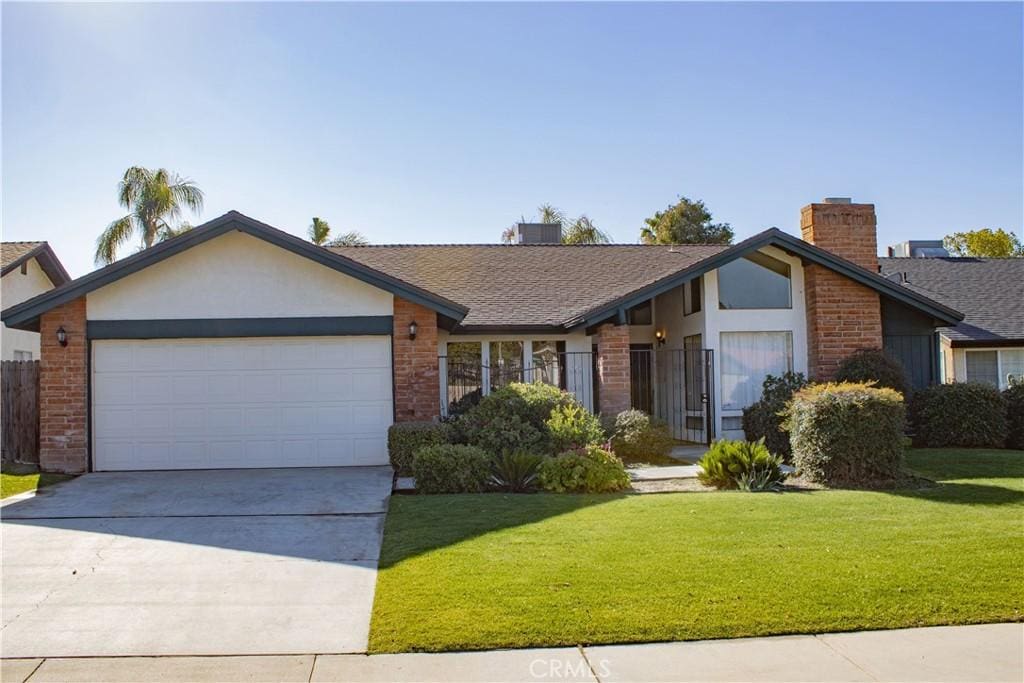 ranch-style house featuring a garage and a front yard