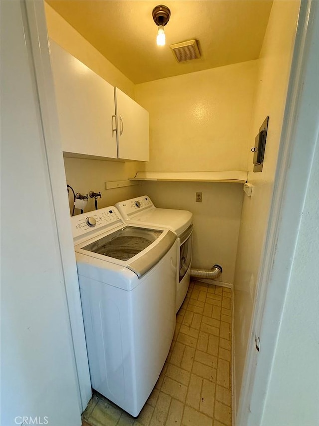 washroom with cabinets and separate washer and dryer