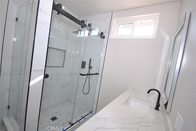 bathroom featuring vanity and a shower with shower door