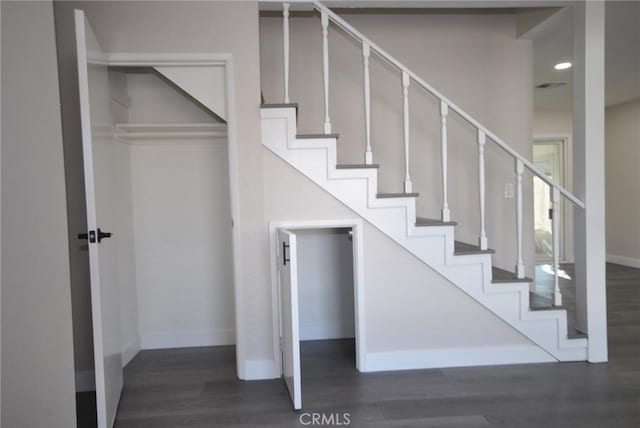 stairway with hardwood / wood-style floors