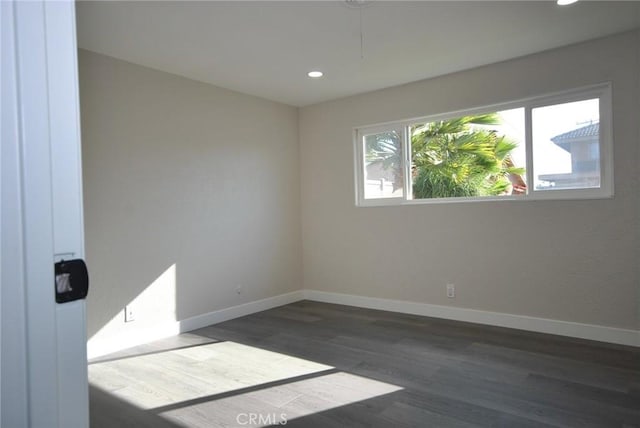 spare room featuring dark hardwood / wood-style floors