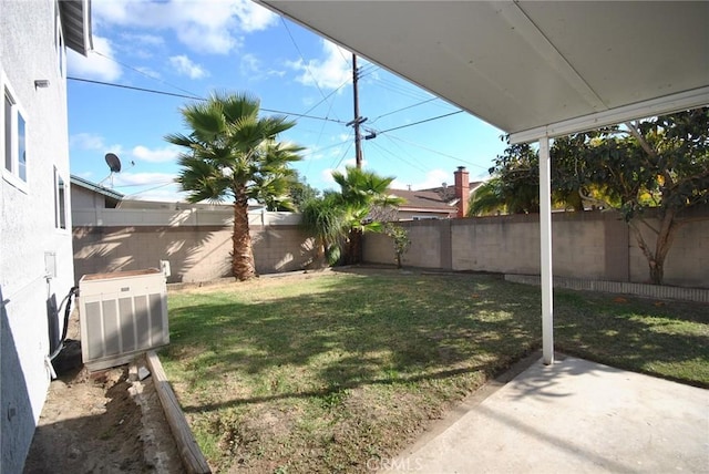 view of yard with central air condition unit and a patio area