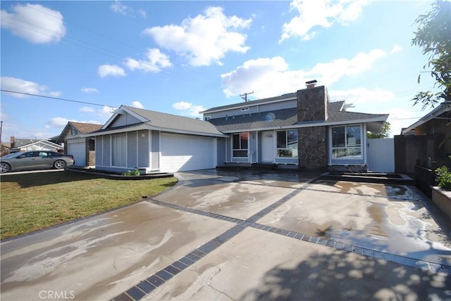 view of front facade with a garage and a front lawn