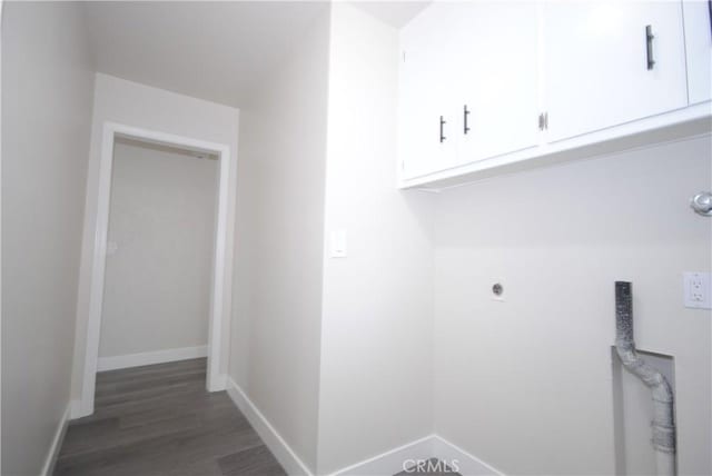 laundry area featuring cabinets, dark hardwood / wood-style floors, and hookup for an electric dryer