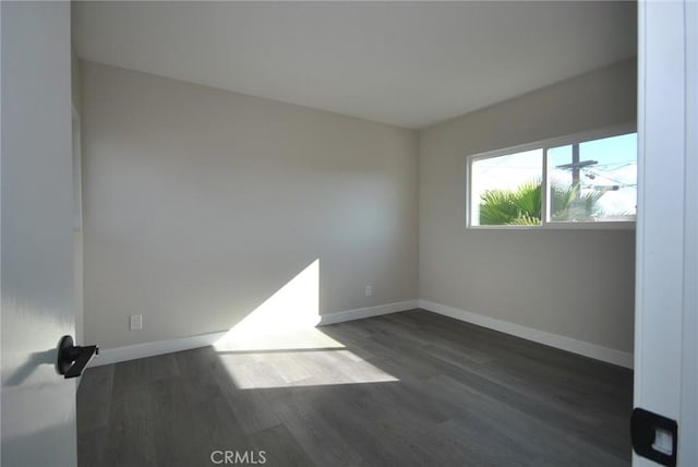 spare room featuring dark hardwood / wood-style flooring