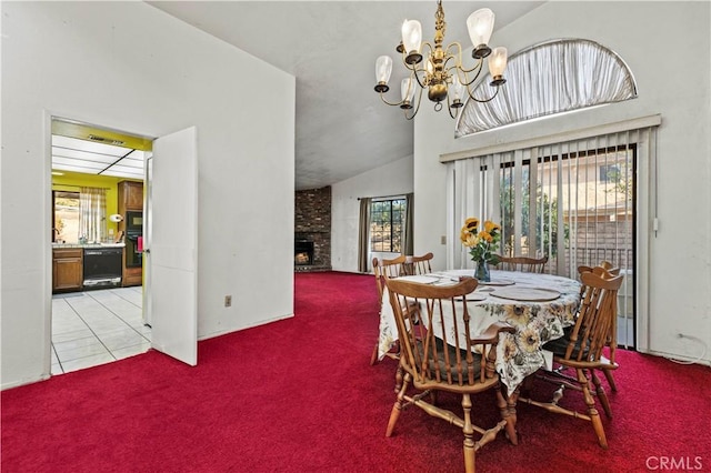 tiled dining area with an inviting chandelier, lofted ceiling, and a fireplace