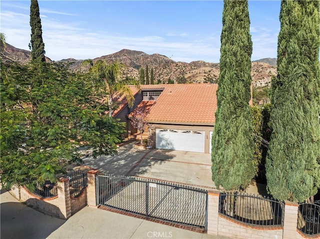 view of front facade featuring a mountain view and a garage