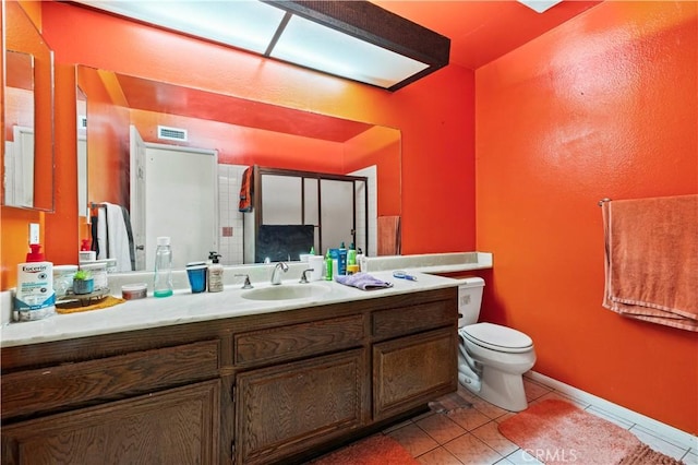 bathroom with an enclosed shower, toilet, tile patterned floors, and vanity