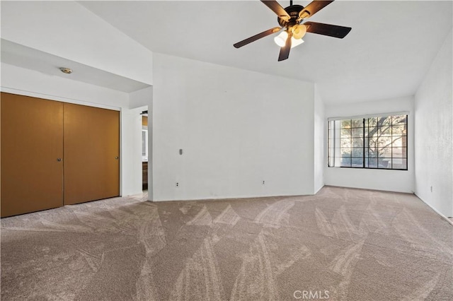 unfurnished bedroom featuring light colored carpet, a closet, and ceiling fan