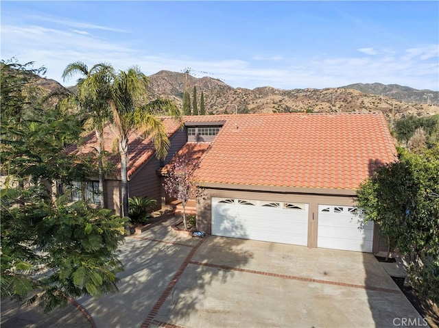 exterior space featuring a mountain view and a garage