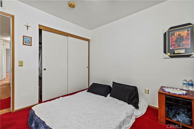 bedroom with carpet floors and a closet