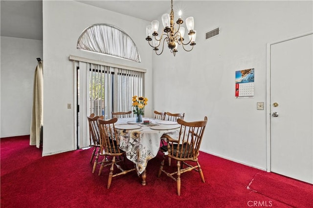 dining area with a notable chandelier, a towering ceiling, and carpet