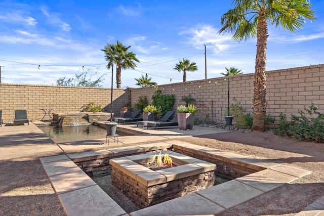 view of patio with a fire pit