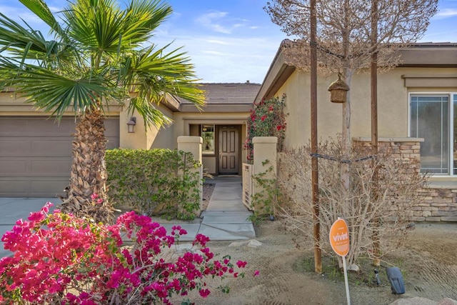 view of exterior entry featuring a garage