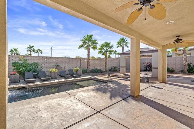 view of patio / terrace with a fenced in pool and ceiling fan