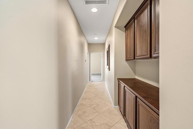 hall featuring light tile patterned floors