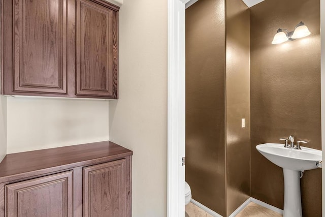 bathroom with sink, tile patterned floors, and toilet