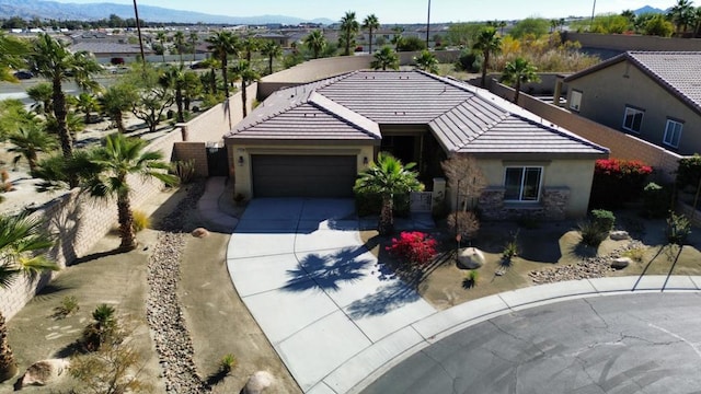 view of front of home with a mountain view and a garage