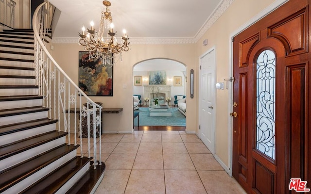 tiled foyer entrance with crown molding