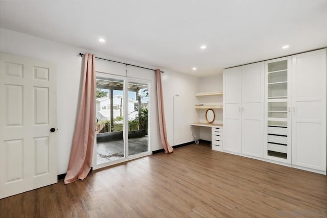 interior space with built in desk, hardwood / wood-style floors, and access to outside