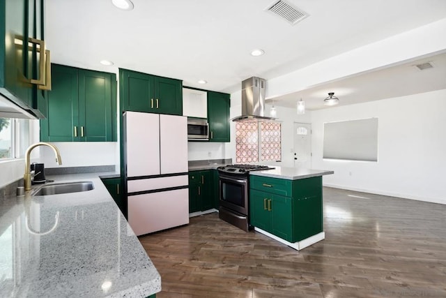 kitchen with green cabinets, island range hood, sink, stainless steel appliances, and light stone counters