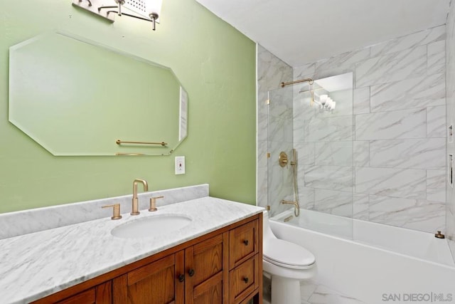 full bathroom featuring toilet, tiled shower / bath, and vanity