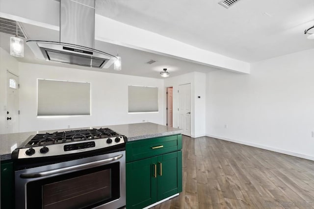 kitchen with stainless steel range with gas cooktop, stone counters, green cabinetry, light hardwood / wood-style floors, and island range hood