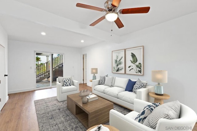 living room with wood-type flooring, beam ceiling, and ceiling fan