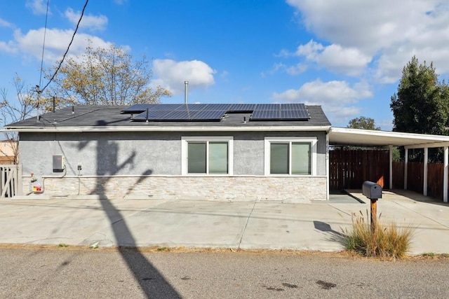 rear view of house featuring a carport