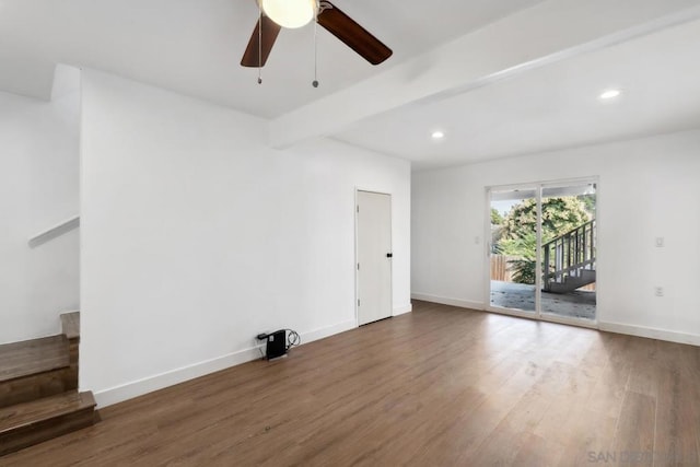 empty room with ceiling fan, dark hardwood / wood-style flooring, and beamed ceiling