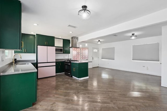 kitchen featuring sink, stove, ventilation hood, a kitchen island, and white fridge