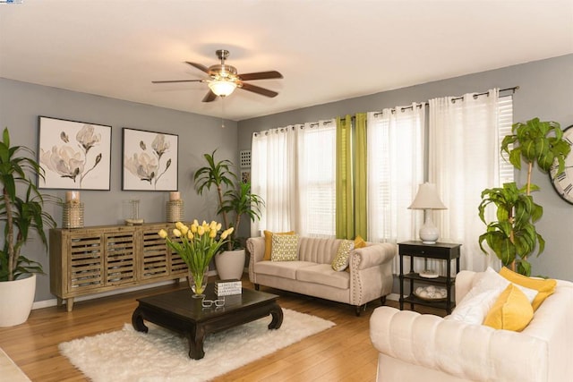 living room featuring hardwood / wood-style flooring and ceiling fan