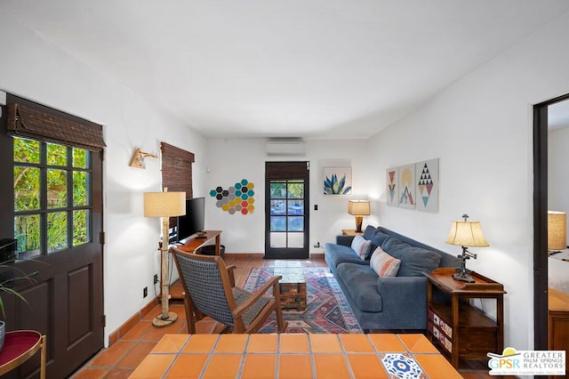 tiled living room featuring a wall mounted AC