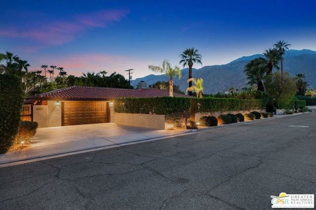 view of front of house featuring a mountain view and a garage