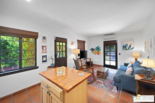 tiled living room with a wall unit AC