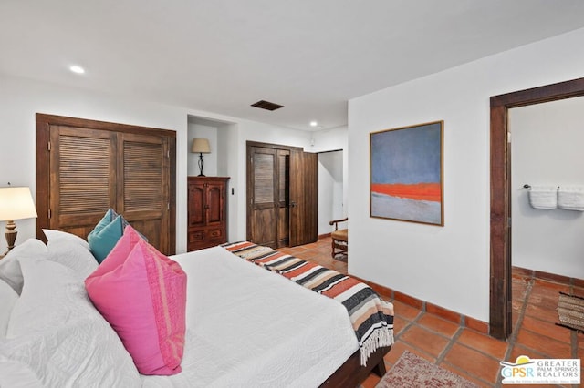 bedroom featuring dark tile patterned flooring