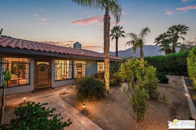 exterior space featuring a mountain view and a patio area