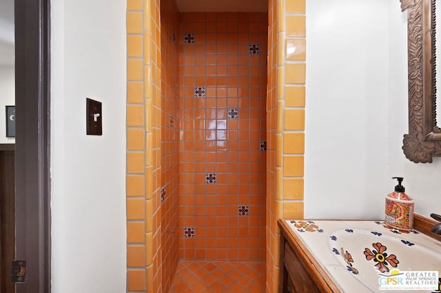 bathroom featuring vanity and tiled shower