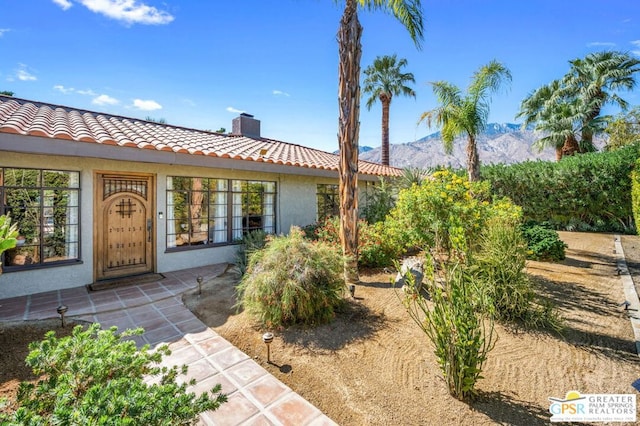 view of exterior entry featuring a mountain view