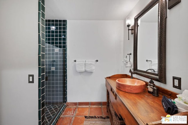 bathroom featuring an enclosed shower, vanity, and tile patterned flooring